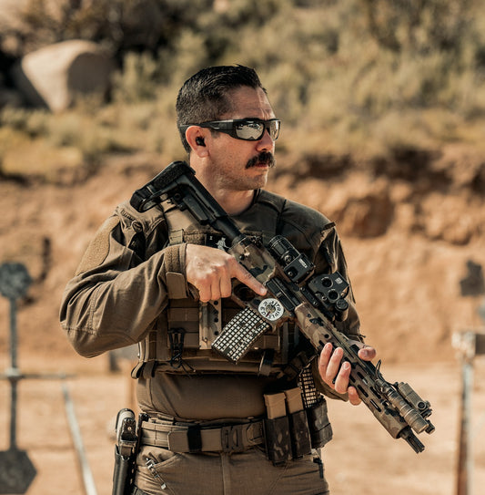 A man in tactical gear is wearing a Kore Essentials B2 ranger green molle battle belt