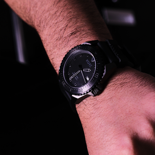 A man shows off his Black Kore Essentials Watch